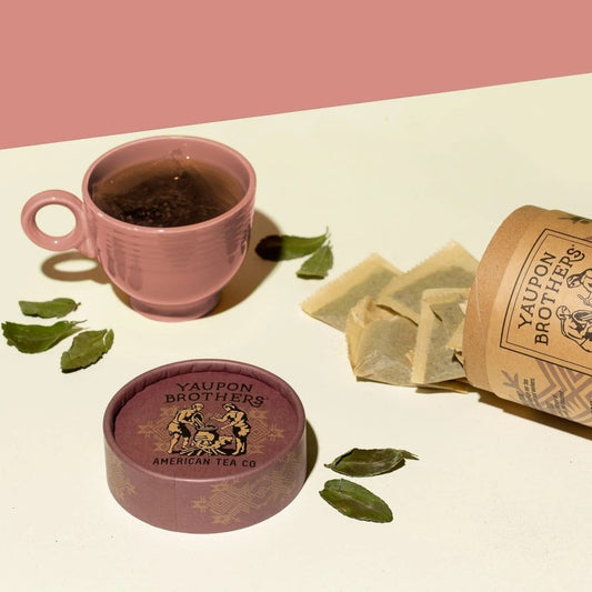 Eco Friendly Canister Of Organic Tea Yaupon Brothers Lavender Coconut Holly Tea Leaves And Cup Of Tea